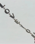 Bracelet with 'LOVE' letters on a light gray background