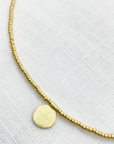 The Makery, Short Gold Beaded Necklace with Brushed Gold Disc